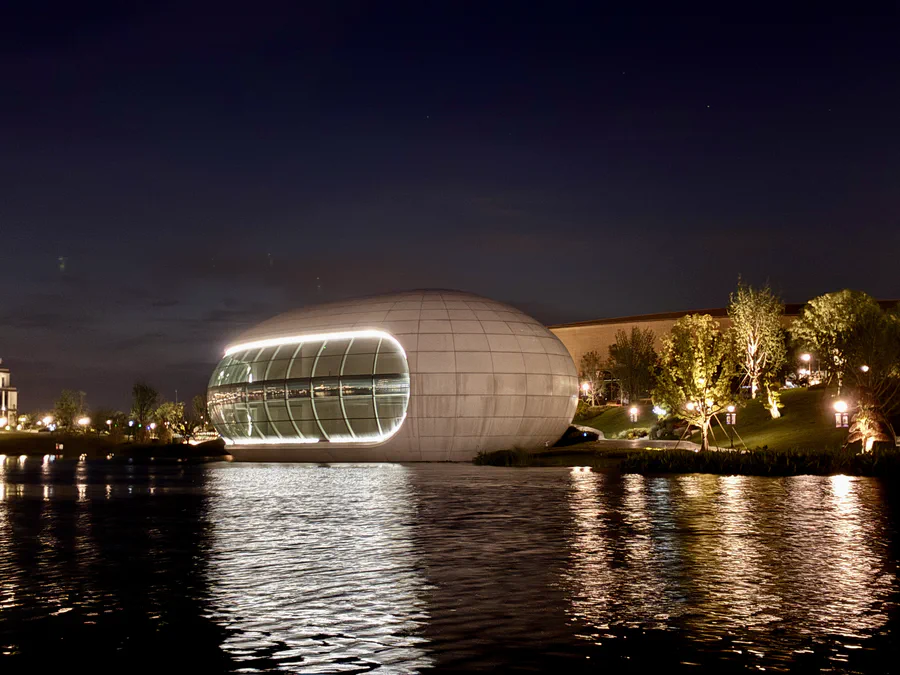 A waterfront pavilion on the Lianqiu Lake campus at night